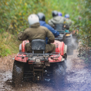 Group of riders riding atv vehicle on off road track, process of driving ATV vehicle, all terrain quad bike vehicle, during offroad competition, crossing mud