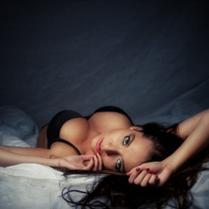 Attractive laying girl with big breasts