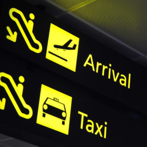 Arrival and taxi signages at the airport for concepts related to travel and transportation, aviation and airport, and vacation.