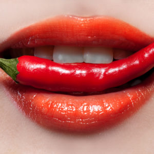 Woman lips and chili pepper