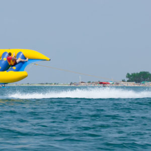 people having fun on batman boat which pulls water bike