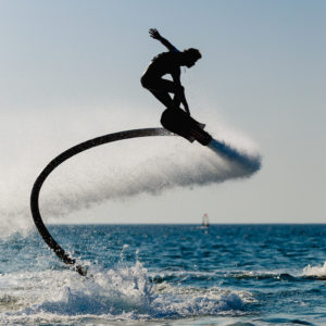 Silhouette of a hover board rider at sea