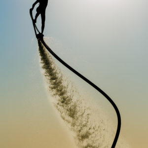 Silhouette of a hover board rider at sea