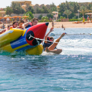 banana boat floating on the water. happy people having fun on banana boat