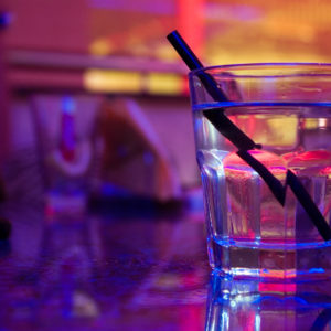 Glass of alcohol drink in the night club
