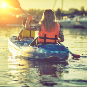 Kayaking and canoeing with family. Children on canoe. Family on kayak ride.