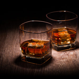 whiskey in glasses on wooden table