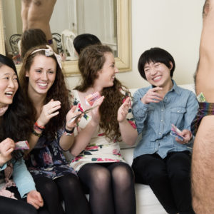 Cheerful young women enjoying while male stripper performing