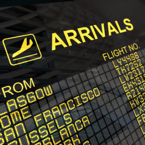 International arrivals board panel with environment reflection