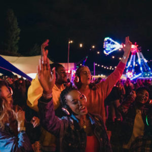Small group of young adults are enjoying a silent disco at a music festival.