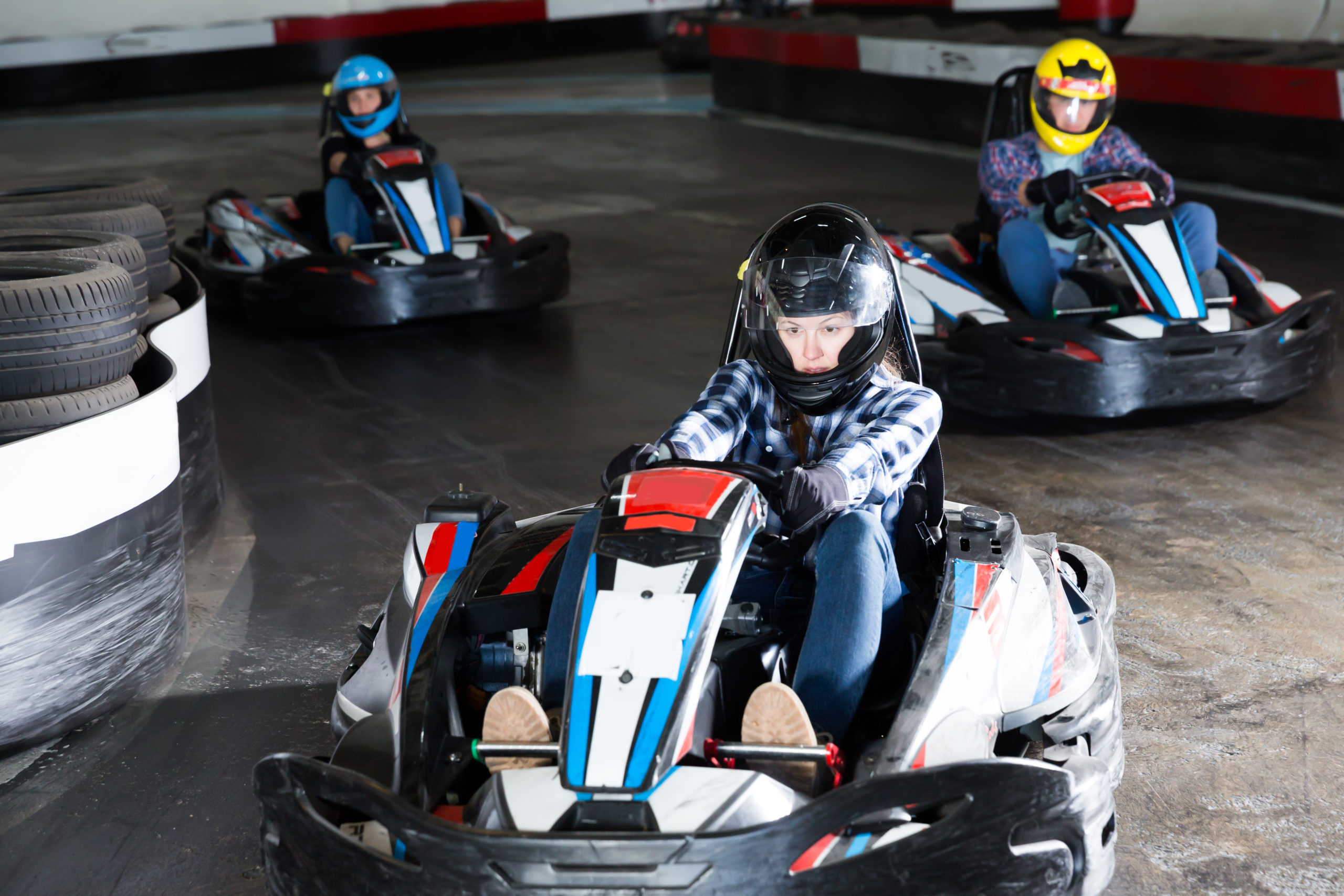 Group of male and females driving racing cars