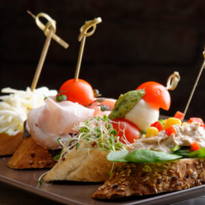 Tapas on Crusty Bread - Selection of Spanish tapas served on a sliced baguette.